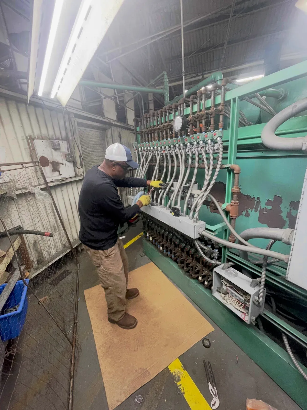 CREATE Industries technician servicing the gas train manifold on a plastics production line